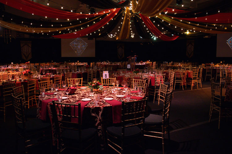 Event tables set with red linens.