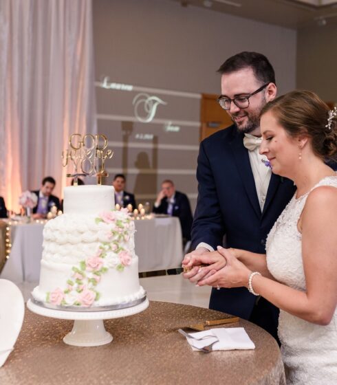 Bride and groom cutting their wedding cake together.