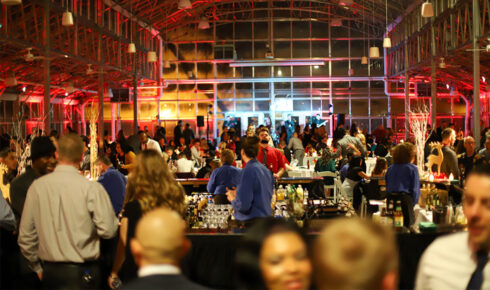 People celebrating a holiday party inside of Greenhouse No. 7