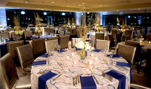 a round table decorated with marble, dark blue, and gold accents inside of the Miller Room