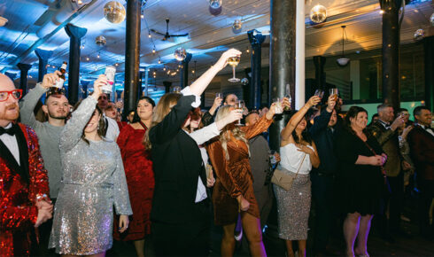 People cheersing and celebrating a holiday party at Historic Pritzlaff Building